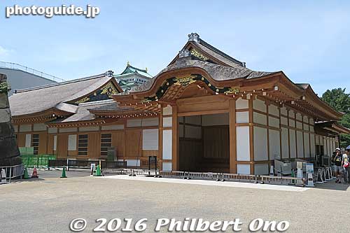 This photo was taken in July 2016 showing the main entrance (called "Kuruma Yose" 車寄 reserved for the castle lord and other VIPs) of the magnificent reconstructed Honmaru Goten Palace.
Above the entrance is an architectural feature called "karahafu" which is a hump-shaped gable commonly seen on important buildings such as castles, temples, and palaces. 
Keywords: aichi nagoya castle