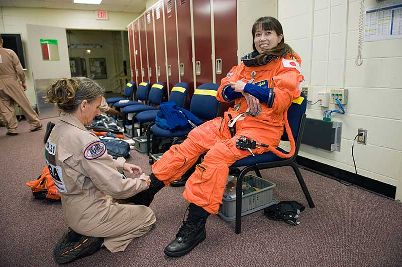 9 Dec. 2009 --- Naoko Yamazaki dons a training version of her shuttle launch and entry suit in preparation for a training session in the Space Vehicle Mock-up Facility...
9 Dec. 2009 --- Japan Aerospace Exploration Agency (JAXA) astronaut Naoko Yamazaki, STS-131 mission specialist, dons a training version of her shuttle launch and entry suit in preparation for a training session in the Space Vehicle Mock-up Facility at NASA's Johnson Space Center. United Space Alliance suit technician Toni Cost-Davis assisted Yamazaki.
