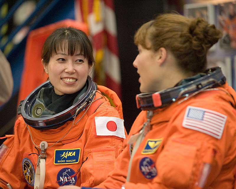 Naoko Yamazaki (left) and NASA astronaut Dorothy Metcalf-Lindenburger, attired in training versions of their shuttle launch and entry suits, await the start of an ingress/egress training session...
29 Jan. 2010) --- Japan Aerospace Exploration Agency (JAXA) astronaut Naoko Yamazaki (left) and NASA astronaut Dorothy Metcalf-Lindenburger, both STS-131 mission specialists, attired in training versions of their shuttle launch and entry suits, await the start of an ingress/egress training session in the Space Vehicle Mock-up Facility at NASA's Johnson Space Center.
