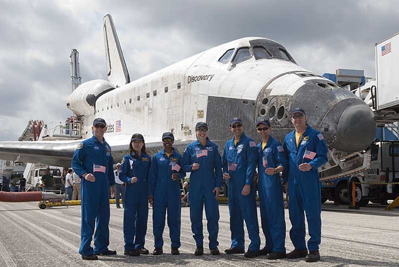 20 April 2010 --- At the Shuttle Landing Facility at NASA's Kennedy Space Center in Florida, members of the STS-131 crew, each holding a flag from his or her country of origin, pose for a portrait in front of space shuttle Discovery.
20 April 2010 --- At the Shuttle Landing Facility at NASA's Kennedy Space Center in Florida, members of the STS-131 crew, each holding a flag from his or her country of origin, pose for a portrait in front of space shuttle Discovery. From the right are NASA astronauts Alan Poindexter, commander; James P. Dutton Jr., pilot; Rick Mastracchio, Dorothy Metcalf-Lindenburger, Stephanie Wilson, Japanese astronaut Naoko Yamazaki and NASA astronaut Clayton Anderson, all mission specialists. Discovery landed on Runway 33 after 15 days in space, completing the more than 6.2-million-mile STS-131 mission on orbit 238. Main gear touchdown was at 9:08:35 a.m. (EDT) on April 20, 2010, followed by nose gear touchdown at 9:08:47 a.m. and wheelstop at 9:09:33 a.m. The seven-member STS-131 crew carried the Leonardo Multi-Purpose Logistics Module, filled with supplies, a new crew sleeping quarters and science racks that were transferred to the International Space Station's laboratories. The crew also switched out a gyroscope on the station's truss, installed a spare ammonia storage tank and retrieved a Japanese experiment from the station's exterior. STS-131 is the 33rd shuttle mission to the station and the 131st shuttle mission overall.

