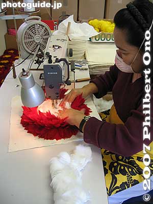 Sewing feather top for uli uli at Aloha Hula Supply
