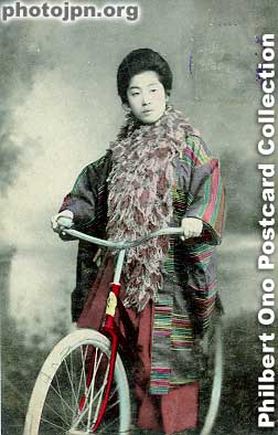 Woman on bicycle. That's a thick shawl she's wearing. Must've been winter. It's unusual to see a bicycle used as a studio prop. Riding a bicycle while wearing a kimono must have been difficult. The postmark looks like 1908. Hand-colored.
Keywords: japanese vintage postcards nihon bijin women beauty kimono