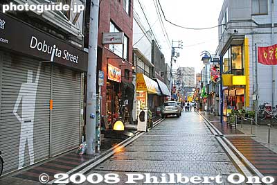The famous Dobuita Street with military shops, bars, etc. "Dobu" means sewer, and "ita" is plank. They once had wooden planks covering a sewer gutter running down the street.
Keywords: kanagawa yokosuka dobuita street bars shops stores military 