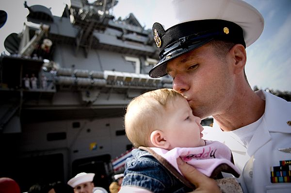 Chief Aviation Machinist Mate David Lyman gives his newborn daughter Emily a kiss during a ceremony for the arrival of the aircraft carrier USS George Washington (CVN 73) to its new home port in Japan.
YOKOSUKA, Japan (Sept. 25, 2008) Chief Aviation Machinist Mate David Lyman gives his newborn daughter Emily a kiss during a ceremony for the arrival of the aircraft carrier USS George Washington (CVN 73) to its new home port in Japan. George Washington and Carrier Air Wing 5 will now operate from Fleet Activities Yokosuka as the U.S. Navy's only forward-deployed aircraft carrier. (U.S. Navy photo by Mass Communication Specialist 2nd Class Kevin S. O'Brien/Released)
