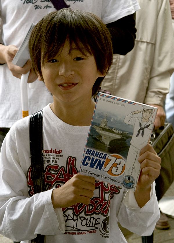 YOKOSUKA, Japan (June 8, 2008) A Japanese child holds up his copy of the manga "CVN 73" during the initial distribution of the comic book outside Commander Fleet Activities Yokosuka.
YOKOSUKA, Japan (June 8, 2008) A Japanese child holds up his copy of the manga "CVN 73" during the initial distribution of the comic book outside Commander Fleet Activities Yokosuka. The manga follows Jack Ohara, a fictitious Japanese-American stationed aboard USS George Washington (CVN 73), as he experiences life on the carrier and arrives for the first time in Japan. U.S. Navy photo by Mass Communication Specialist 3rd Class Matthew R. White (Released)
