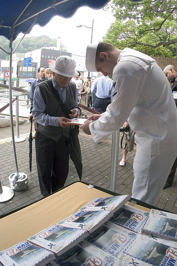 The manga follows Jack Ohara, a fictitious Japanese-American stationed aboard USS George Washington (CVN 73), as he experiences life on the carrier and arrives for the first time in Japan.
YOKOSUKA, Japan (June 8, 2008) Mass Communication Specialist 3rd Class James Verton hands a copy of the manga "CVN 73" to a Japanese citizen during the initial distribution of the comic book outside Commander Fleet Activities Yokosuka. The manga follows Jack Ohara, a fictitious Japanese-American stationed aboard the aircraft carrier USS George Washington (CVN 73), as he experiences life on the carrier and arrives for the first time in Japan. U.S. Navy photo by Mass Communication Specialist 3rd Class Matthew R. White (Released)
