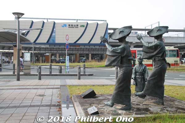 At JR Fukuchiyama Station is this statue of Dokkoise bon dancers dancing to the Fukuchiyama Ondo. 
This song originated with "Dokkoise!" (ドッコイセ) shouted when local workers had to move something heavy (like the stones for the stone walls) while they were building Fukuchiyama Castle in the 16th century on the order of Akechi Mitsuhide.
Keywords: kyoto Fukuchiyama station