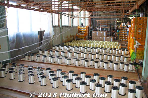 Tayuh Textile Co. makes almost everything, from the silk threads to the fabrics. We toured their impressive factory. 
These are spools of silk being made into threads.
Keywords: kyoto kyotango tango peninsula chirimen silk crepe fabric material textile