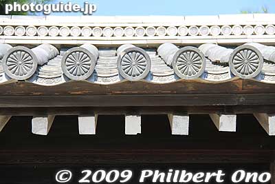 Roof tiles of palace wall. Kyoto Gyoen National Garden is rectangular. It used to be a town of 200 homes of court nobles surrounding the Imperial Palace while the emperor lived in Kyoto. 
Keywords: kyoto imperial palace gosho 