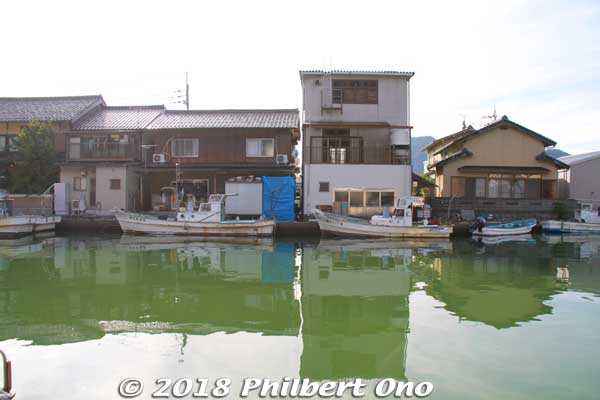 The homes used to have built-in boat garages like at Ine, but they were abolished and the boats are moored right in front instead. 
Keywords: kyoto maizuru yoshihara irie inlet fishing boat house