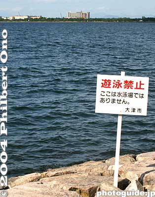 No Swimming
遊泳禁止 - By now you must be getting sick of seeing this word "kinshi." Well, it's certainly not a pleasant word since it limits your freedom. But it also serves to keep you safe. The kanji in red reads "yūei kinshi" meaning "swimming (and playing in the water) prohibited." Below in black reads, "Koko wa suieijō dewa arimasen." This is not a place for swimming.

Place: Lake Biwa at Otsu, Shiga Pref.
Keywords: warning sign photographer