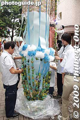 When the decorations are unpacked or unraveled, they are freshened up. 
Keywords: miyagi sendai tanabata matsuri festival tohoku star bamboo decorations 