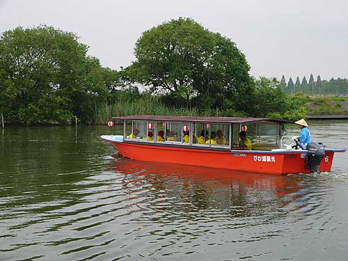 The Scenic Water Channel boat ride uses traditional-looking motorized boats for large groups.
