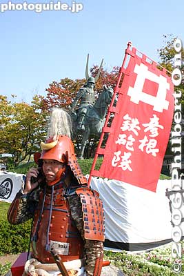The parade has children and adults dressed in historical costumes, especially the red samurai armor which was the trademark of the Ii clan. Even a modern samurai needs a cell phone. 
Keywords: shiga hikone castle parade festival matsuri