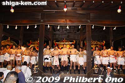 All four groups have arrived and they stand around the mikoshi. There are more people behind the mikoshi as well.
Keywords: shiga otsu sanno sai matsuri festival 