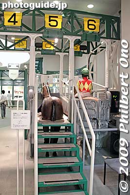 A life-size mock-up of the starting gate. Press a button while sitting on the mannequin horse and the gate will open. Also see [url=http://www.youtube.com/watch?v=j9GkWUmDHUU]my YouTube video here.[/url]
Keywords: tokyo fuchu race course horse racing museum jra 