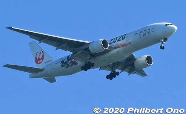 JAL Boeing 777-200 in Tokyo 2020 livery approaches Haneda Airport as it passes over Sea Forest Waterway.