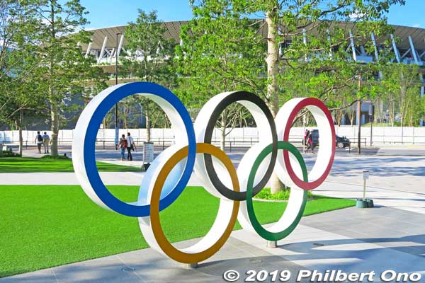 Olympic rings in front of the museum. Olympic Stadium in the background Japan Olympic Museum.