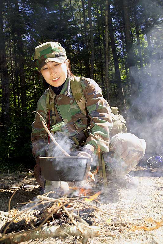 23-26 August 2004 --- Astronaut Naoko Yamazaki boils water over a campfire during 2004 ASCAN land survival training in the wilderness of Maine.
