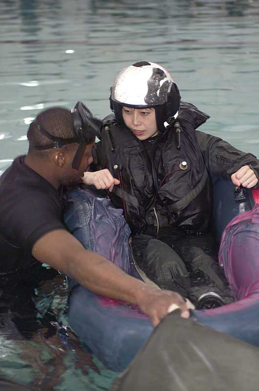 21-25 June 2004 --- Naoko Yamazaki learns about the operation of a life raft during water survival training at Pensacola Naval Air Station.
