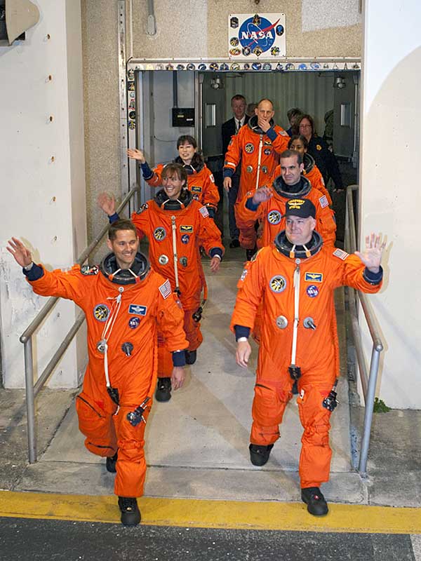 5 April 2010 --- After suiting up, the STS-131 crew members exit the Operations and Checkout Building to board the Astrovan...
5 April 2010 --- After suiting up, the STS-131 crew members exit the Operations and Checkout Building to board the Astrovan, which will take them to launch pad 39A for the launch of space shuttle Discovery on the STS-131 mission. On the right (front to back) are NASA astronauts Alan Poindexter, commander; Rick Mastracchio, Stephanie Wilson and Clayton Anderson, all mission specialists. On the left (front to back) are NASA astronauts James P. Dutton Jr., pilot; Dorothy Metcalf-Lindenburger, and Japan Aerospace Exploration Agency (JAXA) astronaut Naoko Yamazaki, both mission specialists. Liftoff of the STS-131 mission is set for 6:21 a.m. (EDT) on April 5. On STS-131, the seven-member crew will deliver the multi-purpose logistics module Leonardo, filled with supplies, a new crew sleeping quarters and science racks that will be transferred to the International Space Station's laboratories. The crew also will switch out a gyroscope on the station's truss structure, install a spare ammonia storage tank and retrieve a Japanese experiment from the station's exterior. STS-131 is the 33rd shuttle mission to the station and the 131st shuttle mission overall.
