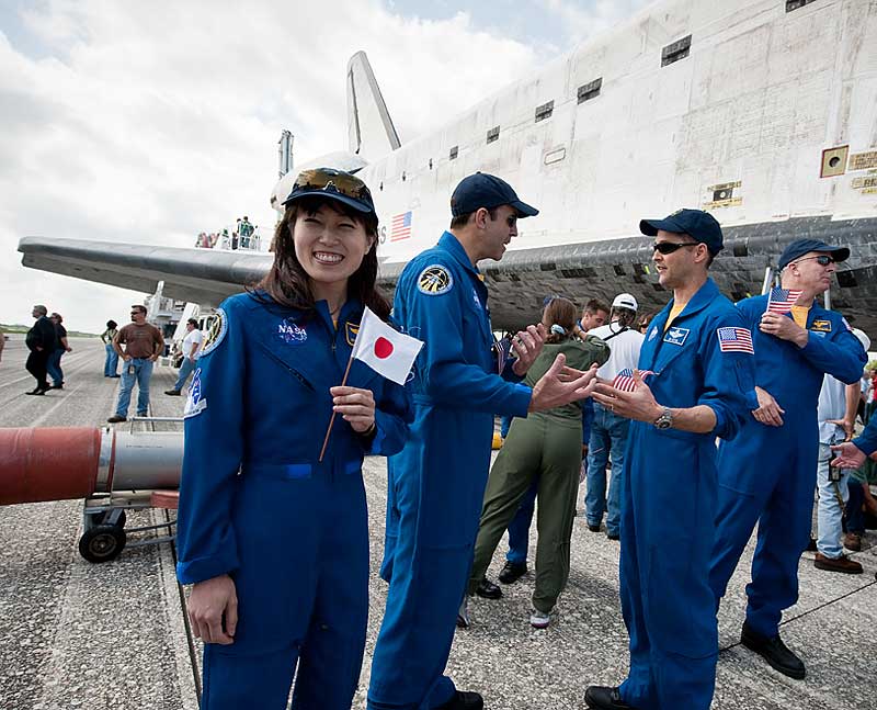 20 April 2010 --- Naoko Yamazaki, holds a Japanese flag near the space shuttle Discovery shortly after Discovery and the STS-131 crew landed at the Kennedy Space Center...
20 April 2010 --- Japanese astronaut Naoko Yamazaki, holds a Japanese flag near the space shuttle Discovery shortly after Discovery and the STS-131 crew landed at the Kennedy Space Center in Cape Canaveral, Fla., on April 20, 2010. NASA astronauts Alan Poindexter, commander; James P. Dutton Jr., pilot; Dorothy Metcalf-Lindenburger, Rick Mastracchio, Stephanie Wilson, Clayton Anderson and Japanese astronaut Naoko Yamazaki, all mission specialists, returned from their 15-day journey of more than 6.2 million miles. The STS-131 mission to the International Space Station delivered science racks, new crew sleeping quarters, equipment and supplies. Photo credit: NASA/Bill Ingalls
