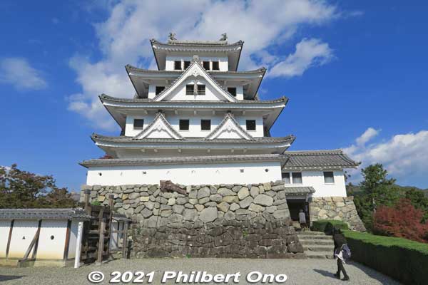 Gujo-Hachiman Castle's tenshu main tower. Reconstruction built in 1933. The original castle was dismantled in 1870 when the samurai system was abolished. Only the stone walls and foundations remained. 
This reconstruction is unusual because it was built using wood instead of concrete. This is in fact Japan's oldest reconstructed main castle tower made of wood.

Entrance to the castle tower can be seen on the right. Small admission charged.

Keywords: gifu Gujo Hachiman Castle japancastle