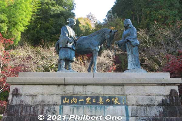 At the foot of the castle mountain, there's this statue of samurai Yamauchi Kazutoyo and his loyal and loving wife Chiyo and the fine horse she bought for him (in Kinomoto or Azuchi, Shiga Prefecture) with her own money in the 16th century. 
Keywords: gifu Gujo Hachiman Castle autumn foliage leaves maples