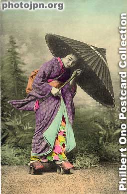 Girl in Storm. Wires were used inside the kimono to make it look wind-blown like in a rainstorm. Even her clogs are for rain. Early photographers commonly imitated the poses and scenes depicted in ukiyoe woodcut prints and Nihonga paintings.
Although the photographer and model were serious in making this picture, it makes you laugh.
Keywords: japanese vintage postcards nihon bijin women beauty kimono