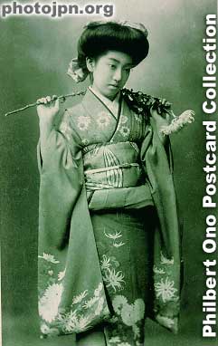 Teruha with chrysanthemum. The flower she's holding matches her kimono design that shows the same flower. Her name was Teruha and she appeared in many postcards. She was born in 1896 in Osaka and worked as a geisha in Shimbashi, Tokyo. Click to read m
Teruha with chrysanthemum. The flower she's holding matches her kimono design that shows the same flower. Her name was Teruha and she appeared in many postcards. She was born in 1896 in Osaka and worked as a geisha in Shimbashi, Tokyo before becoming a Buddhist priest in Kyoto. Read more about her interesting life by James A. Gatlin at geikogallery.com.
Keywords: japanese vintage postcards nihon bijin women woman beauty kimono flowers