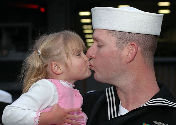 YOKOSUKA, Japan (Nov, 2007) Aviation Electronics Technician 1st Class Jason Sanders kisses his daughter after returning home from the aircraft carrier USS Kitty Hawk's (CV 63) fall deployment.
YOKOSUKA, Japan (Nov, 2007) Aviation Electronics Technician 1st Class Jason Sanders kisses his daughter after returning home from the aircraft carrier USS Kitty Hawk's (CV 63) fall deployment. Kitty Hawk and the embarked Carrier Air Wing (CVW) 5 squadrons participated in exercise ANNUALEX with the Japan Maritime Self-Defense Force during the deployment. Kitty Hawk is the world's only permanently forward-deployed aircraft carrier and operates from Fleet Activities Yokosuka. U.S. Navy photo by Mass Communication Specialist 3rd Class Olivia Giger (Released)
