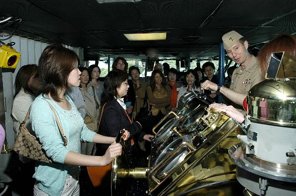 Yokosuka, Japan (April 21, 2006) - Cmdr. Donald Cuddington, Navigator of USS Kitty Hawk (CV 63), explains the function of Kitty Hawk's navigation bridge to members of the Japanese American Wives Association (JAWA).
Yokosuka, Japan (April 21, 2006) - Cmdr. Donald Cuddington, Navigator of USS Kitty Hawk (CV 63), explains the function of Kitty Hawk's navigation bridge to members of the Japanese American Wives Association (JAWA). Tours of Kitty Hawk are conducted to increase public awareness of the aircraft carrier's mission and capabilities. Currently in port, Kitty Hawk demonstrates sea control and power projection as the U.S. Navy's only permanently forward-deployed aircraft carrier. U.S. Navy photo by Photographer's Mate Airman Jimmy C. Pan (RELEASED)
