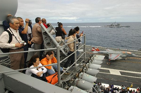 Yokosuka, Japan (Sept. 17, 2006) - Friends and family of USS Kitty Hawk (CV 63) Carrier Strike Group Sailors watch as an EA-6B Prowler from Electronic Warfare Squadron One three Six (VAQ-136), lands during a "Friends and Family Day" cruise.
Yokosuka, Japan (Sept. 17, 2006) - Friends and family of USS Kitty Hawk (CV 63) Carrier Strike Group Sailors watch as an EA-6B Prowler from Electronic Warfare Squadron One three Six (VAQ-136), lands during a "Friends and Family Day" cruise. More than 2,200 family members and guests embarked aboard Kitty Hawk for a day cruise, which included an air power demonstration, shipboard tours and ship maneuvers by three warships of the Kitty Hawk Carrier Strike Group. U.S. Navy photo by Mass Communication Specialist Seaman Thomas J. Holt (RELEASED)
