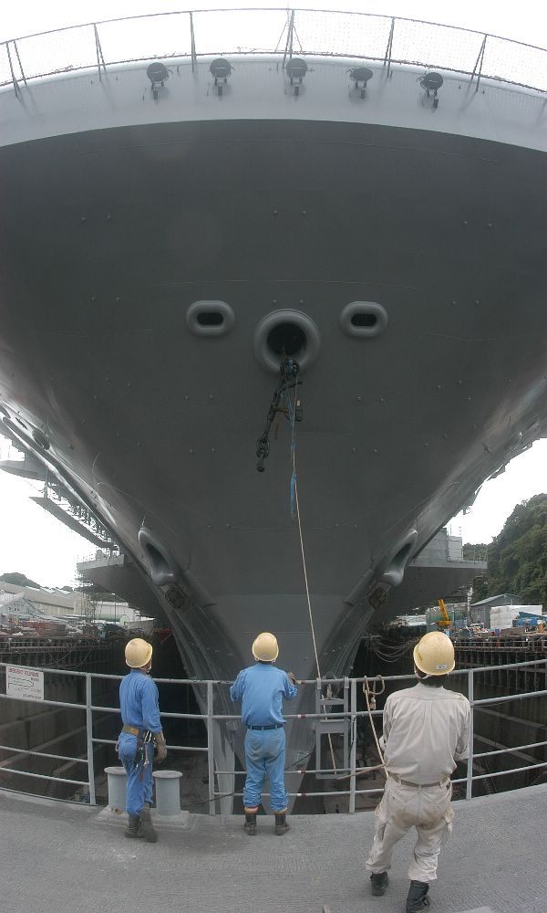 Yokosuka, Japan (Aug. 26, 2003) -- Workers from Ship Repair Facility, Yokosuka, Japan, hoist freshly painted chain stoppers back into the forecastle aboard USS Kitty Hawk.
Yokosuka, Japan (Aug. 26, 2003) -- Workers from Ship Repair Facility, Yokosuka, Japan, hoist freshly painted chain stoppers back into the forecastle aboard USS Kitty Hawk (CV 63). Kitty Hawk is currently undergoing an extensive scheduled maintenance cycle. Kitty Hawk is America's oldest active warship, and the worlds only permanently forward deployed aircraft carrier, operating out of Yokosuka, Japan. U.S. Navy photo by Photographer’s Mate Airman Bo Flannigan. (RELEASED)
