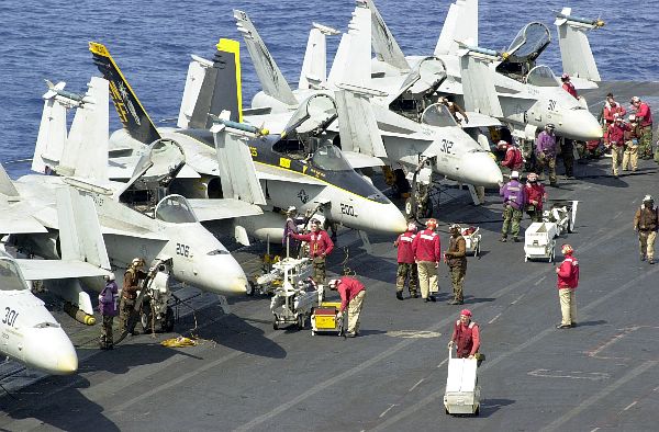 At sea aboard USS Kitty Hawk (CV 63) Apr. 24, 2002 -- Flight deck personnel prepare F/A-18 “Hornet” strike fighter aircraft for the next round of flight operations.
At sea aboard USS Kitty Hawk (CV 63) Apr. 24, 2002 -- Flight deck personnel prepare F/A-18 “Hornet” strike fighter aircraft for the next round of flight operations. Kitty Hawk is providing a forward presence in the Asia-Pacific region, conducting training and exercises with its regional allies. Kitty Hawk is the Navy’s only permanently forward-deployed aircraft carrier operating out of Yokosuka, Japan. U.S. Navy photo by Photographer’s Mate 3rd Class John E. Wood. (RELEASED)
