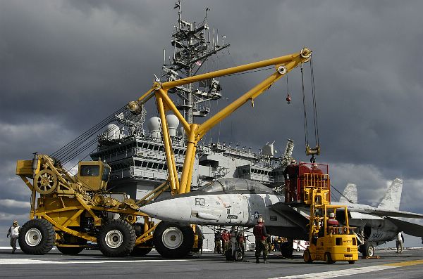 Pacific Ocean (Jan. 13, 2005) - Crash-and-salvage personnel rig a training skeleton of an F-14 Tomcat to "Tilly," a mobile crane used aboard USS Kitty Hawk (CV 63).
Pacific Ocean (Jan. 13, 2005) - Crash-and-salvage personnel rig a training skeleton of an F-14 Tomcat to "Tilly," a mobile crane used aboard USS Kitty Hawk (CV 63). Tilly is used to move damaged aircraft off the flight line during crash and salvage operations. Kitty Hawk's crash-and-salvage team serves as the ship's flight deck firefighting crew. Currently conducting sea trials in the western Pacific Ocean, Kitty Hawk demonstrates power projection and sea control as the U.S. Navy's only permanently forward-deployed aircraft carrier, operating from Yokosuka, Japan. U.S. Navy photo by Photographer's Mate 3rd Class Bo Flannigan (RELEASED)
