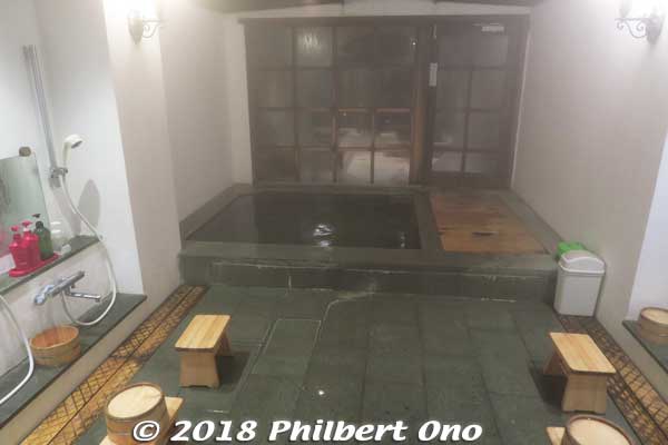 This is the other bath named “Vidro-no-Yu” (ビードロの湯) and also designed by Alexander Wilds and his artist wife Yukiko Oka. The indoor part. 
The glass windows were a design highlight (hard to see because of the steam and dark night). The glass door opens to a balcony with a bath.
Keywords: kyoto kyotango Tango Peninsula Shorenkan Yoshinoya hot spring ryokan onsen inn