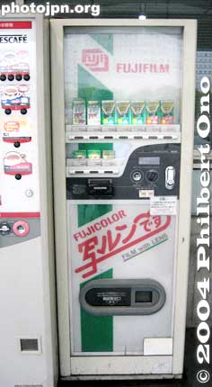 Disposable Cameras
写るんです - Next to a coffee machine on the left, this is a vending machine selling single-use cameras (or film with lens). 

FujiFilm was the first to introduce these cameras (in 1986). Their single-use camera brand is called "Utsurundesu" (the red characters on the machine) meaning "it takes photos." It comes from the word "utsuru" which means capture (an image). It is also the first character in the word "shashin（写真）.

Other film makers came up with their own cutsey names. These cameras, though, are on its way out as digital cameras and camera phones dominate.
