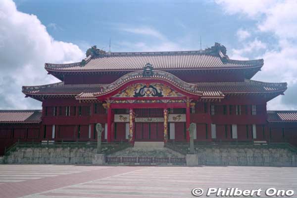 The ornate Seiden Hall, Shuri Castle's most important and central building and National Treasure. Saw it on a previous trip. 
Very ornate building with wood carvings, lacquered surfaces, paintings, and sculptures. It was meticulously rebuilt in 1992. (首里城 正殿)

Notice the stone dragon pillars flanking the center entrance and sculptures of dragon heads and lion head on the red roof tile roof.
Keywords: okinawa naha shuri castle gusuku japancastle