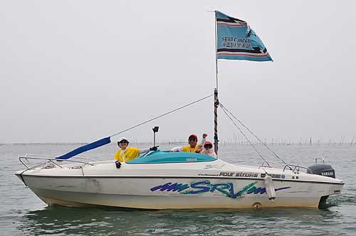 Motor boat flying Seta Rowing Club's flag.
