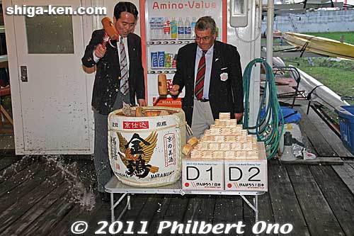 A Japanese tradition of smashing open a barrel of sake or rice wine. The stack of square wooden cups on the right emblazoned with "FISA World Rowing Tour in Biwako" was also given as a souvenir to the rowers.
