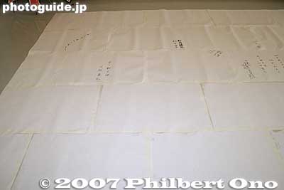 The sheets are joined in the same pattern as a brick wall. Every other row of sheets has a half sheet along the edge. Notice the autographs of people on the paper.
Keywords: shiga higashiomi giant kite festival making odako matsuri