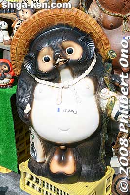 Shigaraki tanuki is said to bear Eight Lucky Omens (八相縁起).
Shigaraki tanuki is said to bear Eight Lucky Omens (八相縁起). 1. The hat is protection from unexpected disasters. 2. The smiling face is for affability, 3. The large eyes is for seeing the situation and making correct and considerate decisions, 4. The large belly is for being calm as well as bold, 5. A sake flask in the left hand for innate virtue, 6. An unpaid bill in the left hand symbolizes trust, 7. Large gonads between the legs which is the money bag for prosperity, and 8. A thick tail for reliability and stability no matter what.
Keywords: shiga koka shigaraki tanuki raccoon dog pottery