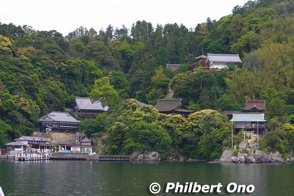 Chikubushima (竹生島) is a small, sacred island dominated by a temple/shrine complex called Hogonji (宝厳寺) perched on this fairly steep slope. 
The temple/shrine's construction was ordered by the emperor in 724 when he proclaimed that Chikubushima was a sacred place for the goddess Benzaiten (弁才天). The temple was to bring national peace, bountiful harvests, and prosperity to all. A priest named Gyoki (僧行基) then proceeded to build the temple with Benzaiten as the principal object of worship.
Keywords: shiga nagahama Lake Biwa Chikubushima Hogonji