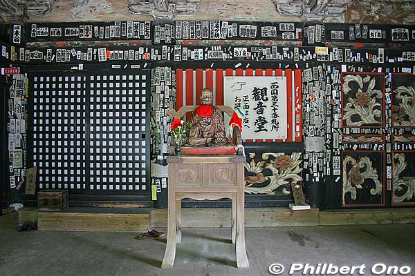 Before photo of a very old and worn statue of Pindola Bharadvaja (賓頭盧尊者). Traditionally, you touch his body part corresponding to the part of your body you want to heal. 
Notice the pillars and ceiling beams which were plastered with pilgrim name stickers called "senjafuda" (千社札). They bear the ardent pilgrim's name and pilgrims stuck their name stickers on the temples they visited to indicate "I wuz here!" 
Keywords: shiga nagahama Lake Biwa Chikubushima Hogonji Kannon-do