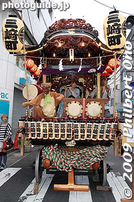 During the Edo Period, the floats originally had dolls. But since the late Meiji Period, the floats have become sculptured wooden floats. Eight of the floats were lost during World War II, but they were rebuilt. So some of them look quite new. 
Keywords: tokyo hachioji matsuri festival floats 