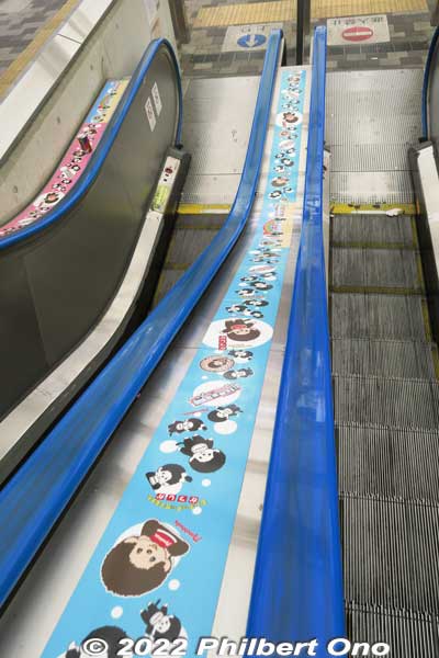 Escalator handrail decorated with Monchicchi. 
Keywords: tokyo katsushika shin-koiwa Monchicchi