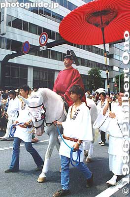 Shrine priest on horseback. The start of one of Tokyo's Big Three Festivals. These photos show the festival's climax on the last day of the festival when over 50 portable shrines are paraded along the streets amid splashing water. It is the Rengo 
Keywords: tokyo koto-ku fukagawa hachiman matsuri festival japanpriest