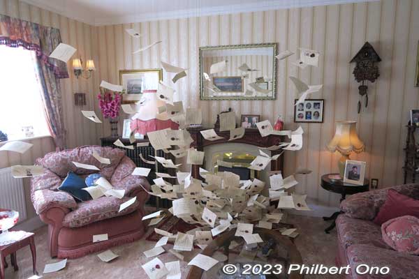 Living room filled with Hogwarts school acceptance letters (delivered by owls) addressed to Harry.
