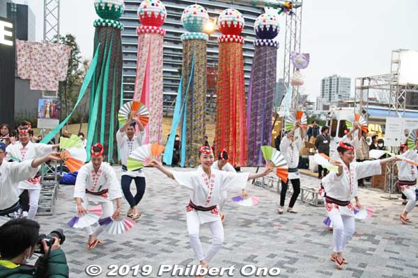 Outside Gate E, there was a short pre-event performance of the Sendai Suzume Odori dance from Sendai, Miyagi Prefecture. 
The Suzume Odori (Sparrow Dance) is held in late July near Sendai Station. They performed in front of Tanabata streamers for which Sendai is famous in early Aug. 仙台すずめ踊り http://www.suzume-odori.com/
Keywords: tokyo shinjuku olympic national stadium